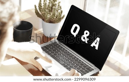 Businessman typing text Q and A in laptop on office background Royalty-Free Stock Photo #2299096309