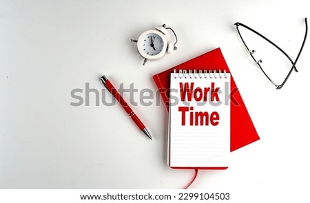 WORK TIME text on a notebook , red pen and notebook, business concept, white background