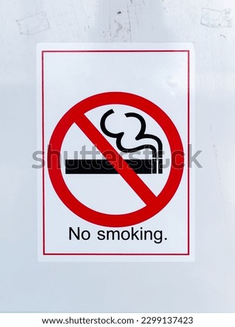 Vertical No Smoking Sign Isolated on Grunge White Wall Background.