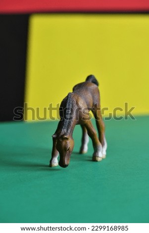 Toy figure of wild brown horse.