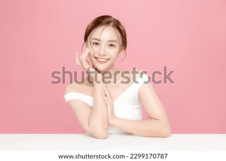 Young Asian beauty woman pulled back hair with korean makeup style touch her face and perfect skin on isolated pink background. Facial treatment, Cosmetology, plastic surgery. Royalty-Free Stock Photo #2299170787