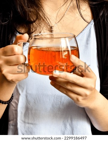A Glass of Tea in a Hand