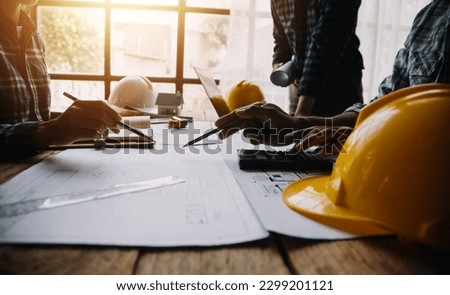 Two Specialists Inspect Commercial, Industrial Building Construction Site. Real Estate Project with Civil Engineer, Investor Use Laptop. In the Background Crane, Skyscraper Concrete Formwork Frames Royalty-Free Stock Photo #2299201121