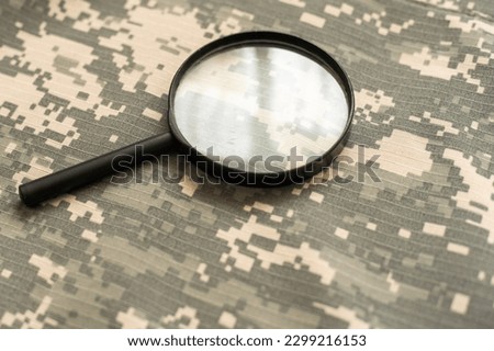 black magnifier on green military uniform