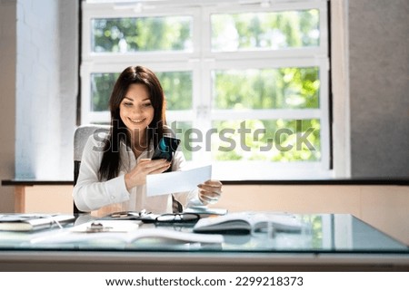 Remote Cheque Deposit Using Mobile Phone. Check Capture Royalty-Free Stock Photo #2299218373