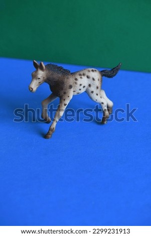 Toy horse looks like running shot from above with a macro lens.