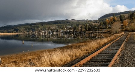 Wheeler, Oregon, USA - November 28, 2022:  Views of tracks on a rainy day along the Nehalem River. Royalty-Free Stock Photo #2299232633