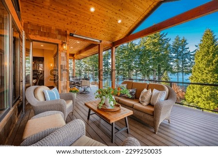 large expansive deck porch patio with furnishings front door dining table comfortable lounge chairs