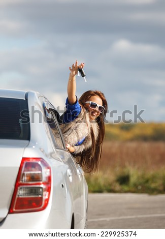 woman smiling showing new car keys