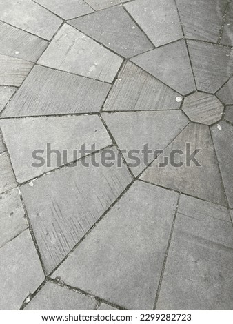 Street geometry. Old gray paving slabs in the form of trapezoids radiating from the center.