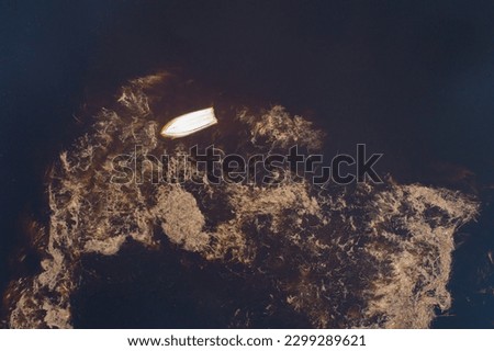 An aerial of a flooded meadow with an upside boat in rural Estonia, Northern Europe