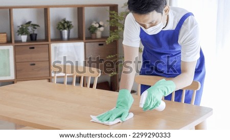 Asian male cleaner with apron