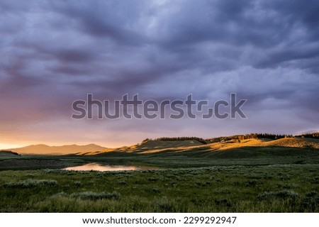 Yellowstone River Meanders Through Hayden Valley At Sunset in summer Royalty-Free Stock Photo #2299292947