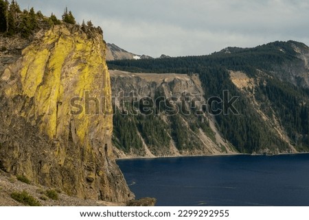Yellow Lichen And Blue Lake Along Rim Drive Of Crater Lake National Park Royalty-Free Stock Photo #2299292955