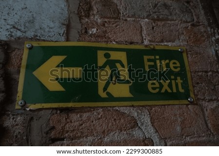 Fire exit sign on brick wall
