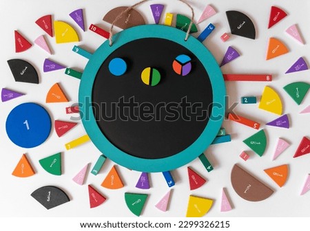 Math fractions  and chalk board on white background. Interesting math for kids. Education, back to school concept. Geometry and mathematics materials. Close up	