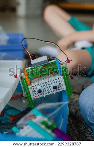 schoolboy study in a robotics class, assemble a robot constructor