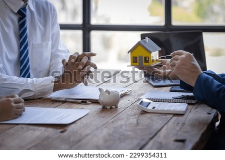 Closeup of Happy asian couple customers sign mortgage loan contract. Making lease and buy and sell house And contract home insurance mortgage loan concept