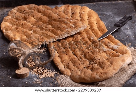 Flatbread with sesame, flatbread, sesame, dough, bread, fresh from the oven, loose, airy, bake, delicious, Royalty-Free Stock Photo #2299389239
