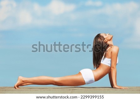 Woman, cobra and stretch yoga on blue sky, exercise and outdoor with zen, underwear and on fitness mockup. Workout, peaceful mindset and wellness with female yogi stretching body, pilates and peace