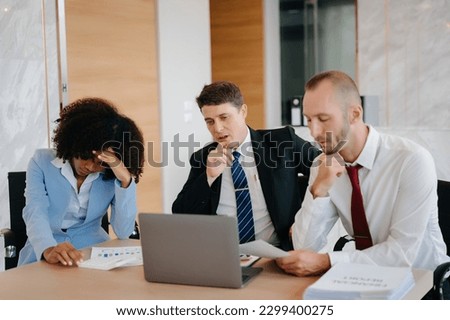 Team thinking of problem solution at modern office meeting, sad diverse business people group shocked by bad news, upset colleagues in panic after company bankruptcy concept Royalty-Free Stock Photo #2299400275