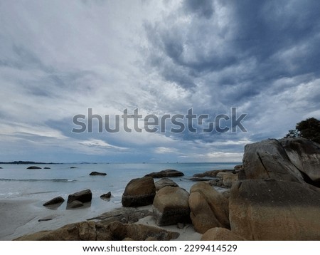 Jambosag Beach in Bangka Island is famous at its gigantic granite rocks and white sands. This picture was taken under the grayish sky