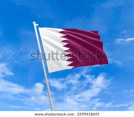 Flag on Qatar flag pole and blue sky, Flag of Qatar fluttering in blue sky big national symbol. Waving white and claret red Qatar flag, Independence Constitution Day. Royalty-Free Stock Photo #2299418695