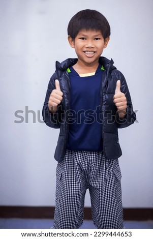 Asian boy taking pictures wearing clothes to travel