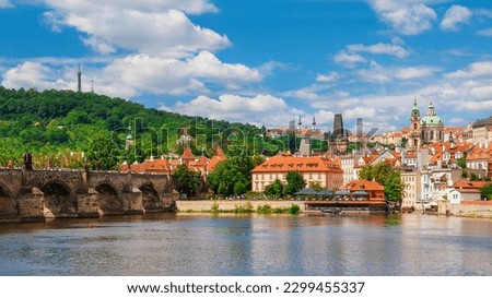 View of Prague Mala Strana old district and River Vltala with the famous Charles Bridge and Petrin Hill Royalty-Free Stock Photo #2299455337