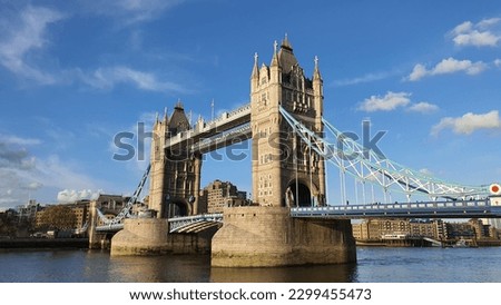 Tower bridge London in the evening before coronation day. Famous tourist spot of London England. Old bridge that across on Thames river and evening blue sky with white clouds. Tower bridge long shot. Royalty-Free Stock Photo #2299455473