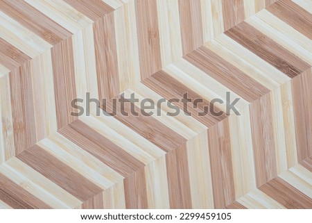 Bamboo blocks in two bright colors arranged in a chevron pattern. Wooden background texture