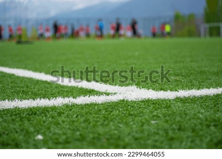 focused soccer field lines. Young soccer players training on the soccer field in the background.