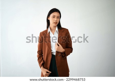 Portrait photo of young beautiful Asian woman feeling happy and holding smart phone, tablet and laptop with black empty screen on white background can use for product presenting concept.
