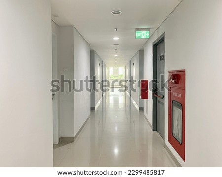Corridor and emergency exit with fire hydrant Royalty-Free Stock Photo #2299485817
