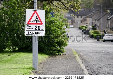 Skid risk road speed limit safety sign