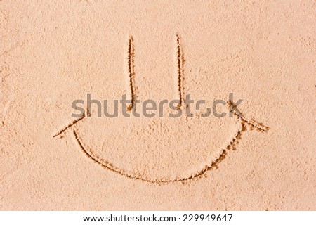 smiley face on the wet sand