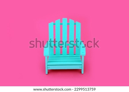 Trendy solitary slatted wooden blue chair on vivid pink background. Independent, modern contemporary stylish furniture, colour, contrast, concept. Copy space.  Royalty-Free Stock Photo #2299513759