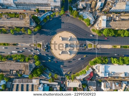 Aerial view of Democracy monument, a roundabout, with cars on busy street road in Bangkok Downtown skyline, urban city at sunset, Thailand. Landmark architecture landscape. Royalty-Free Stock Photo #2299550923