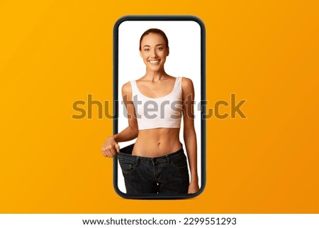 Smiling young european woman in sportswear enjoy weight loss result on smartphone screen, isolated on orange studio background, collage. App for sports, weight loss, fitness and blog