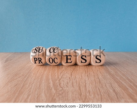 Success business process symbol. Turned wooden cubes with words 'success process'. Beautiful blue background, copy space. Success business process concept.