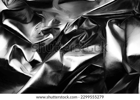 crumpled metallic reflector black and white background texture 