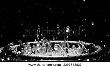 Water splashes on audio speaker. Vibrations of low bass over water in a music speaker. Black bass woofer. Subwoofer with water. The liquid jumps to the rhythm of the music at the party. Slow motion Royalty-Free Stock Photo #2299563829