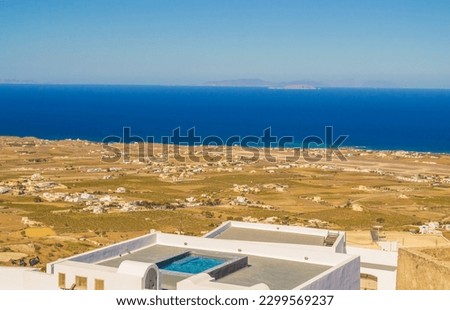 .In the picture can be seen eastern side of the island,,Ios and Sikinos islands in the distance,with vineyards and Kamari village beach.September 2013