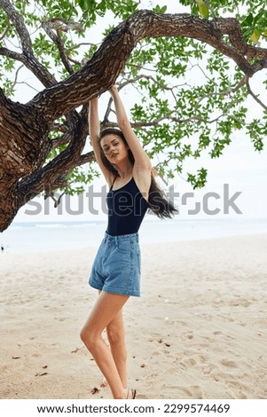 woman sea nature smiling sky hanging relax bikini tree vacation lifestyle