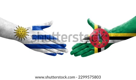Handshake between Dominica and Uruguay flags painted on hands, isolated transparent image.