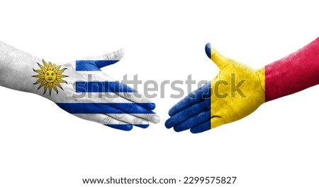 Handshake between Chad and Uruguay flags painted on hands, isolated transparent image.