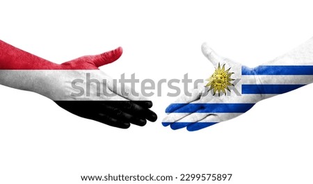 Handshake between Uruguay and Yemen flags painted on hands, isolated transparent image.