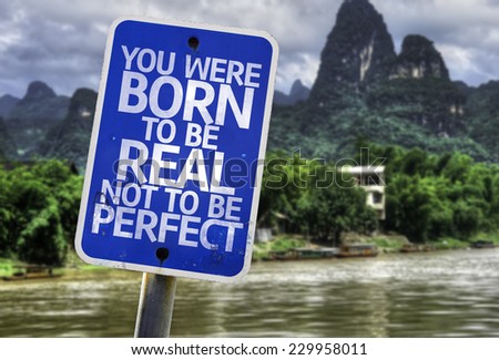 You Were Born To Be Real Not To Be Perfect sign with a forest background