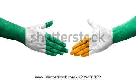 Handshake between Ivory Coast and Nigeria flags painted on hands, isolated transparent image.