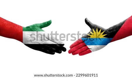 Handshake between Antigua and Barbuda and UAE flags painted on hands, isolated transparent image.